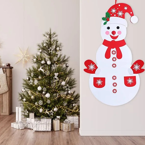DIY felt snowman hung on a wall beside a Christmas tree