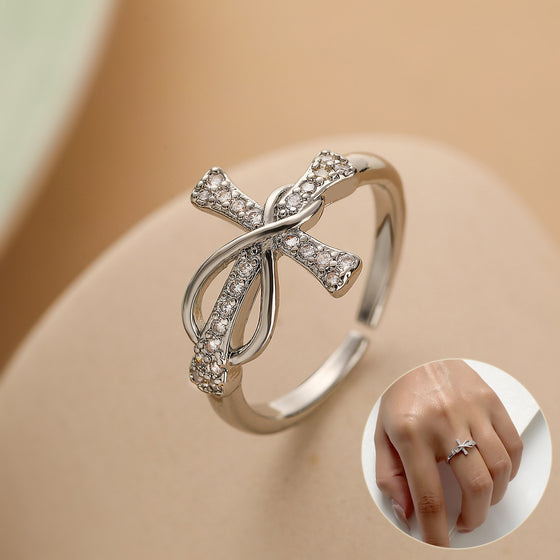 Silver-tone rhinestone bow ring with an inset of the ring worn