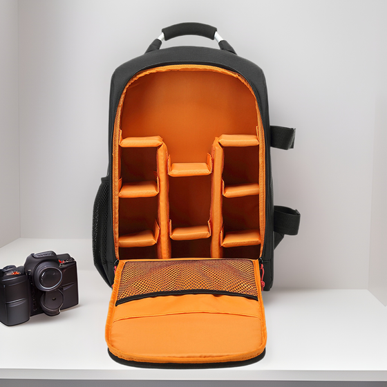 Camera backpack open with orange padded dividers and a camera
