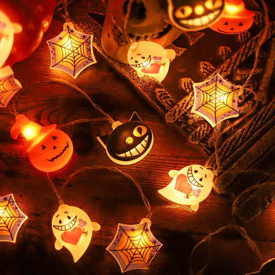Glowing pumpkin, cat, ghost and spider web lights on a string