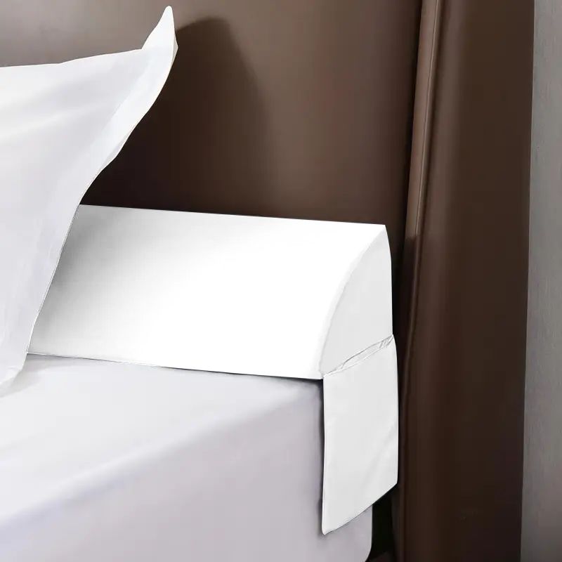 White gap filler pillow tucked against a headboard