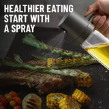 Olive oil sprayer next to a roasting tray