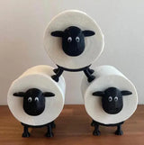 Sheep-face toilet paper roll holder close-up showing black plastic face and legs frame