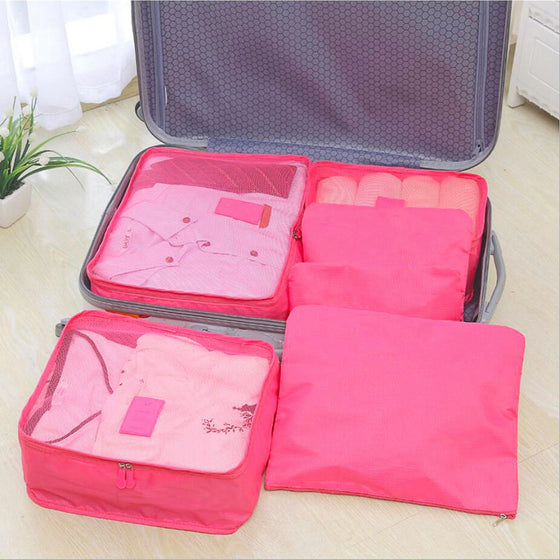 Hot pink packing cubes inside an open suitcase
