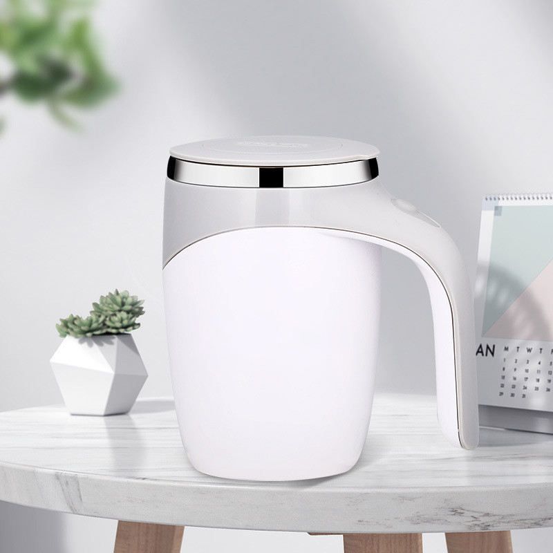 Self stirring electric mug with coffee