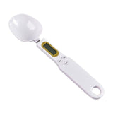 Digital spoon scale measuring coffee beans