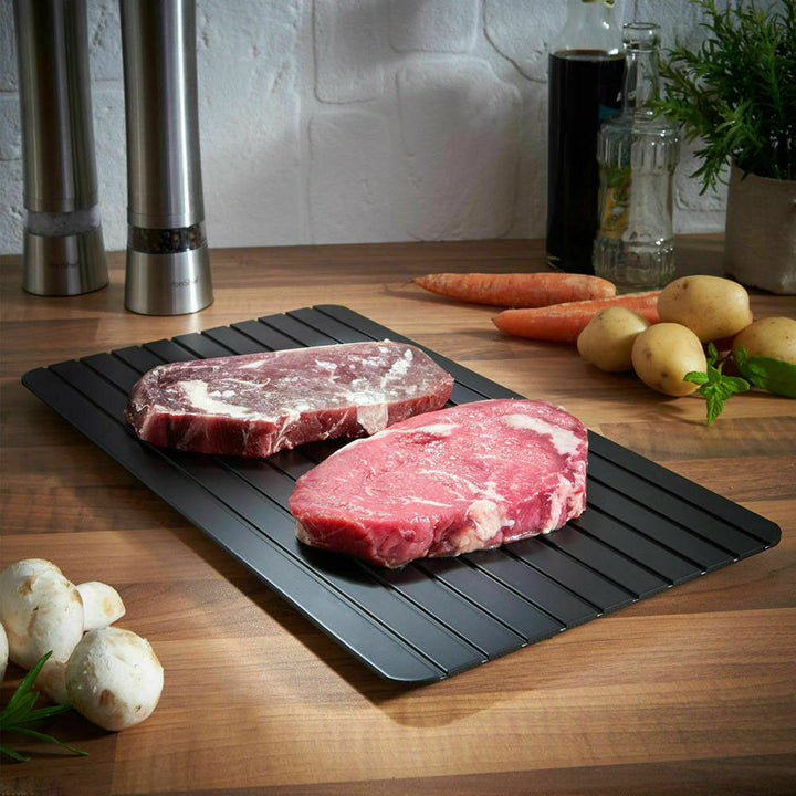 Defrost tray thawing frozen steak