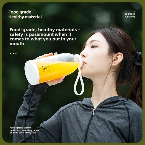 Woman drinking from the portable juicer cup outdoors