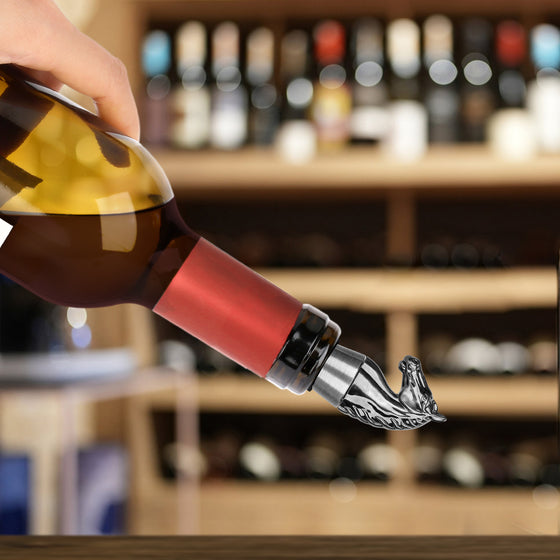 Silver horse head stopper sealing a wine bottle being poured