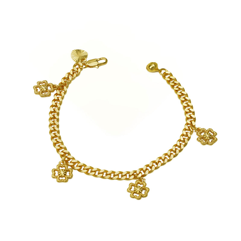 Gold curb chain bracelet with dangling four-leaf clover charms, laid in a circle