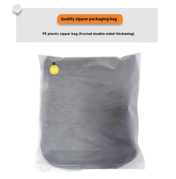 Gray dog vest folded inside a zip packaging bag