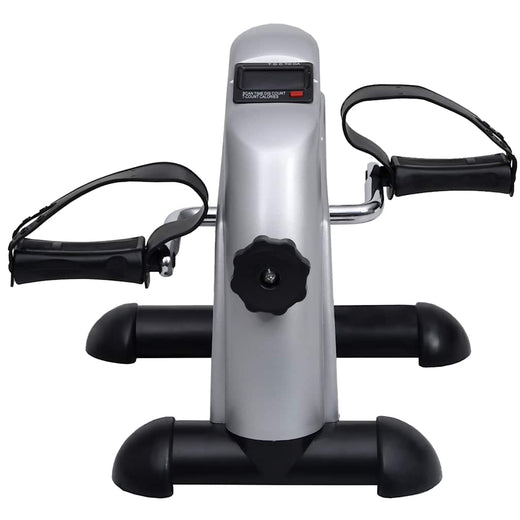 Pedal bike trainer positioned under a desk while working