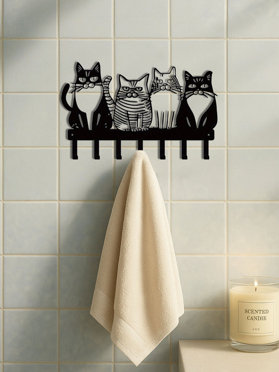 Cat wall hook rack holding a towel on a tiled wall