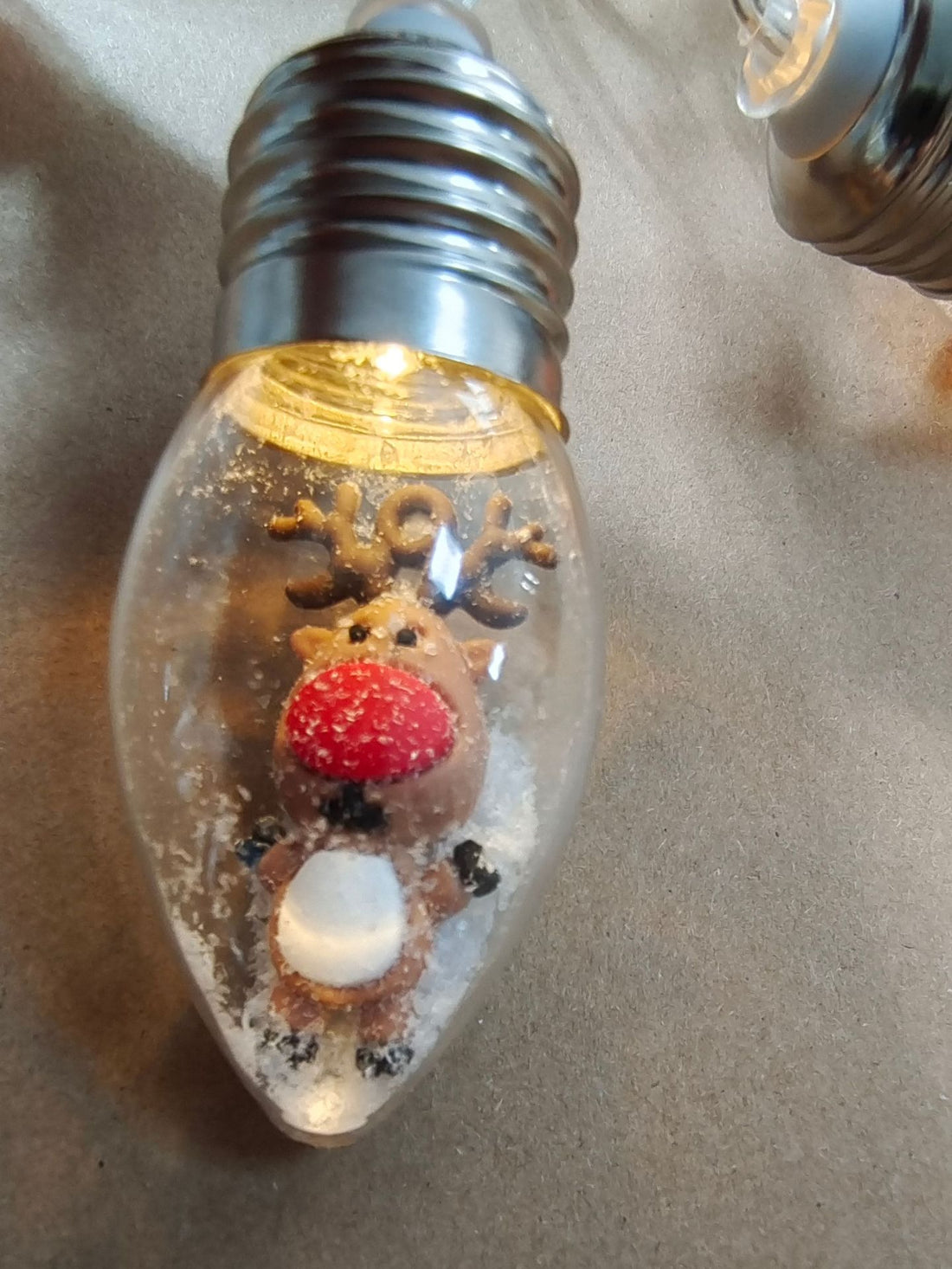 Clear bulb string light with a miniature reindeer figure inside, Little Dear option
