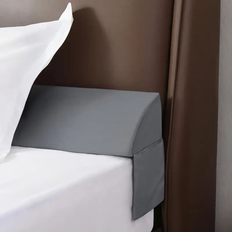 Gray gap filler pillow between a mattress and headboard