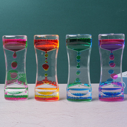 Liquid hourglass timer tipped over showing flow