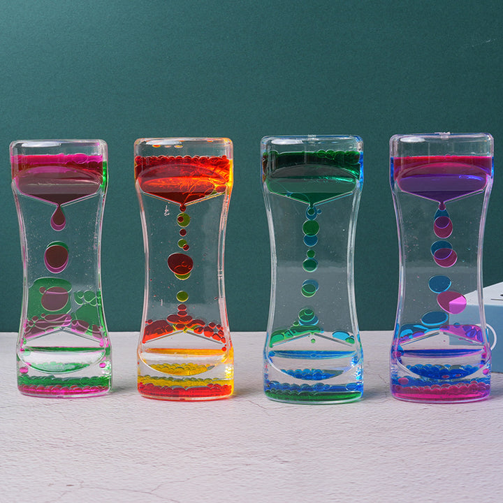 Liquid hourglass timer tipped over showing flow