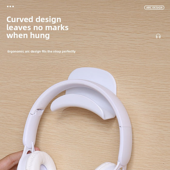 White curved hook with white headphones hanging from it