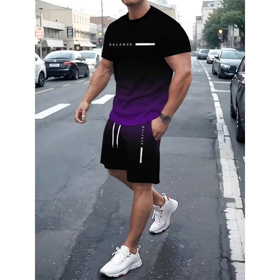 Man in a purple gradient T-shirt and black shorts set on a street
