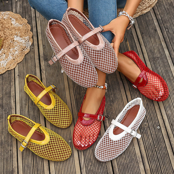 Pink, yellow, red and white mesh Mary Jane flats on a wooden deck