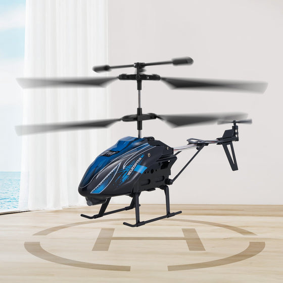 Blue RC helicopter hovering above a landing pad indoors
