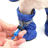 Dog boots shown in the orange colorway with drawstring closure