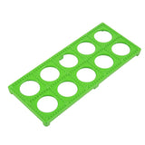 Green plastic ravioli mold tray with ten circular indents