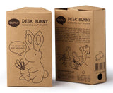 Bunny scissors holder shown on a craft table with wrapping paper