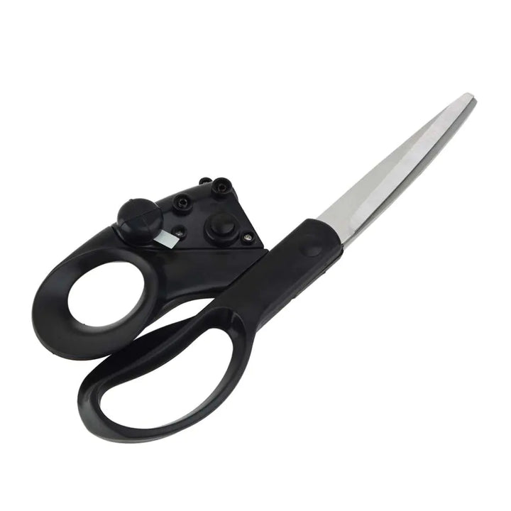 Scissors cutting fabric along a marked pattern line