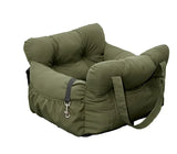 Small dog resting in the padded car seat interior
