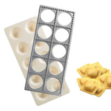 Metal cutter tray and plastic mold tray stacked together with filled ravioli
