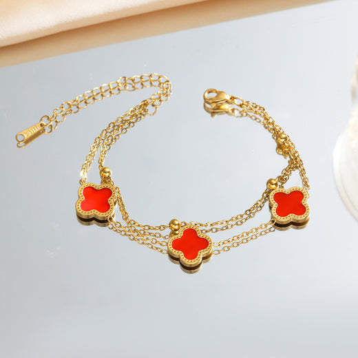 Red four-leaf clover charm bracelet, gold-tone double chain, product photo