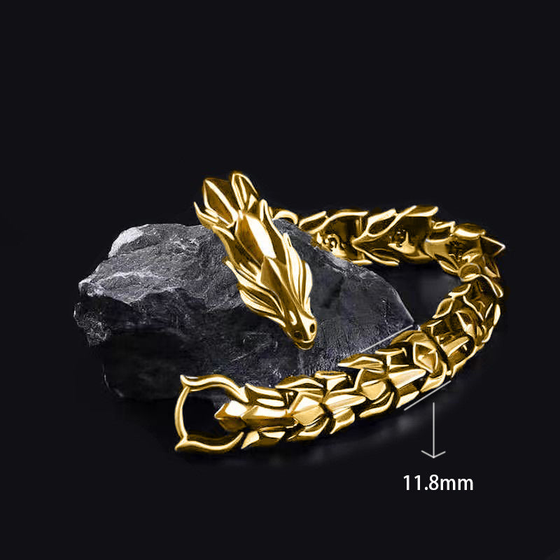 Gold bracelet with dragon design on a dark background