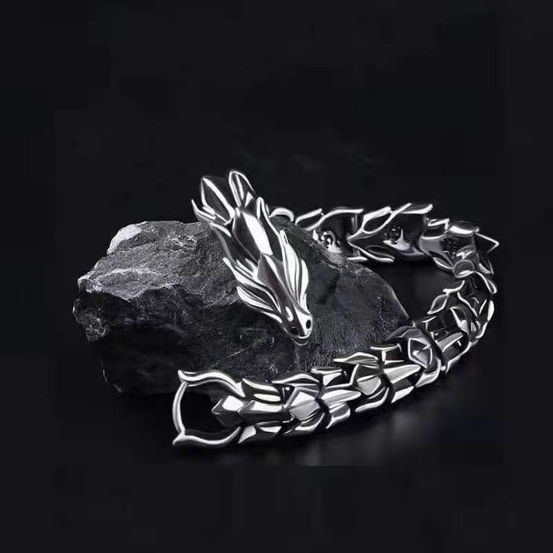 Silver dragon bracelet on a dark background
