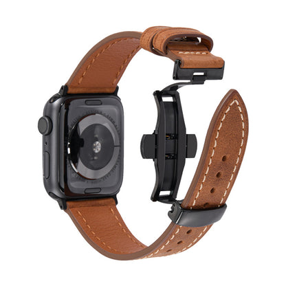Brown leather watch strap with black metal clasp on a white background