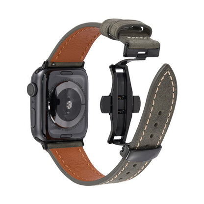 Smartwatch with a brown leather band and a gray strap on a white background