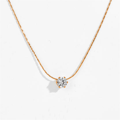 A delicate rose gold necklace with a single round-cut clear gemstone pendant, displayed against a clean white background.