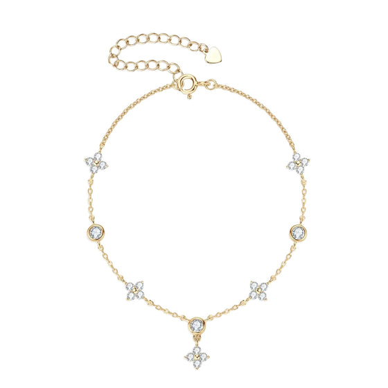 Gold four-leaf clover anklet chain with clear stone charms, dangling clover pendant, and extender clasp