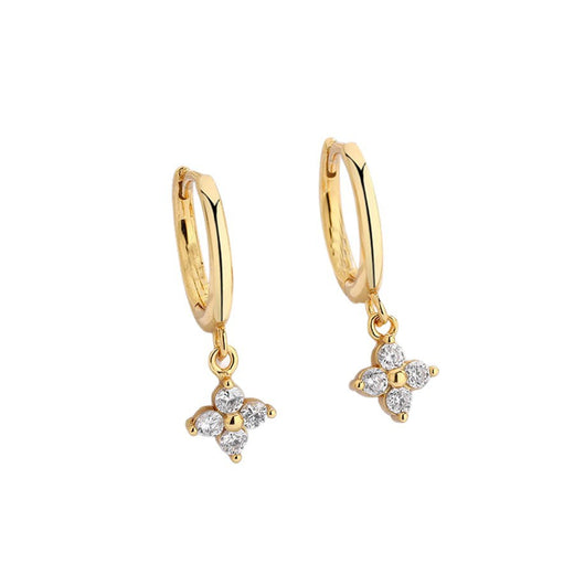 Gold-tone four-leaf clover charm huggie hoop earrings on a white background
