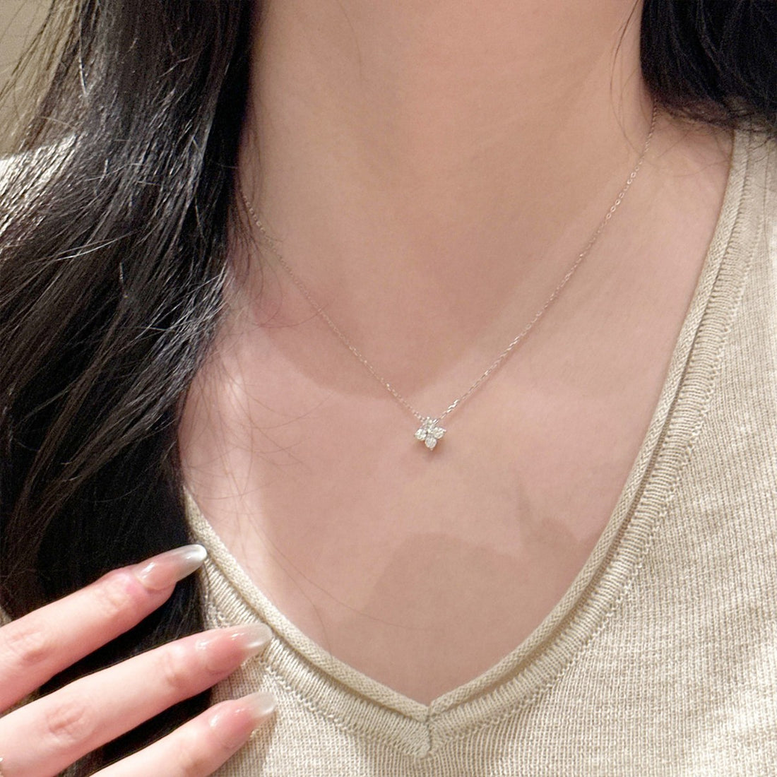 Model wearing the four-leaf clover pendant necklace at clavicle length