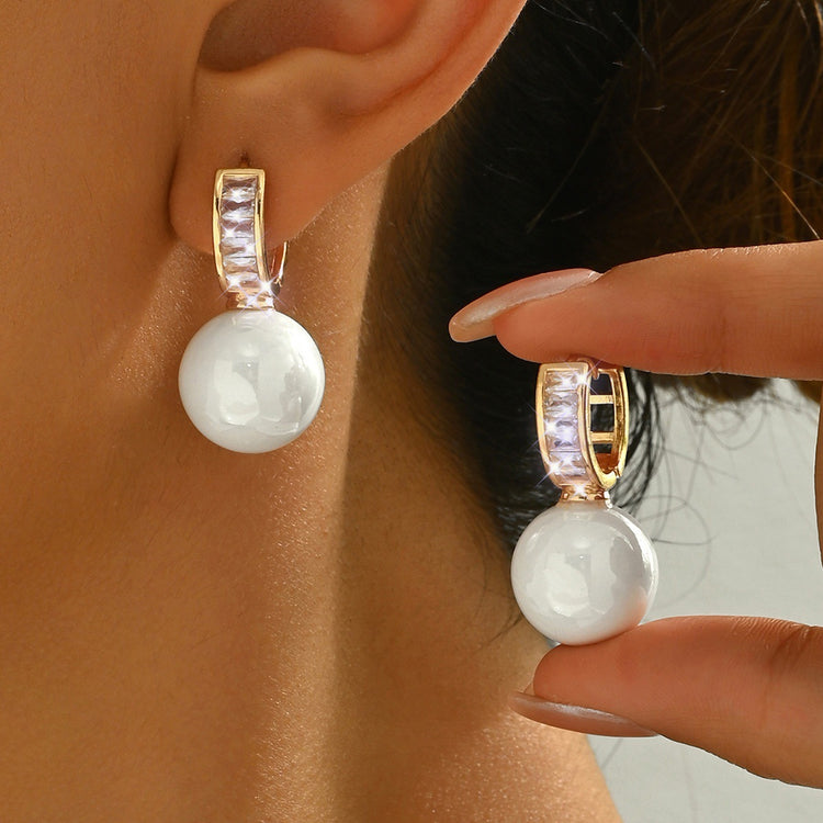 Simple Light Luxury Ear Buckle in white pearl with crystal pave huggie hoop, worn on ear