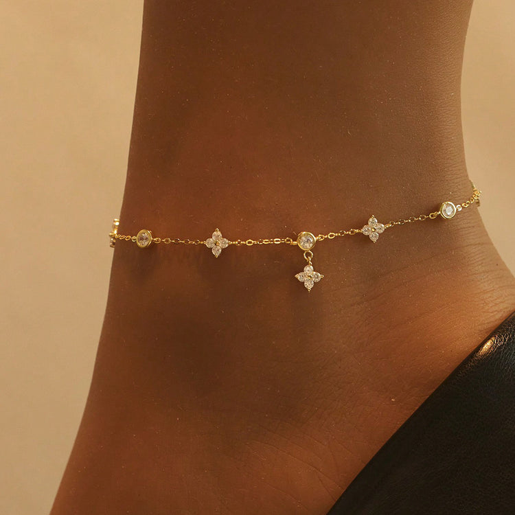 Gold sterling silver clover and star charm anklet worn on ankle