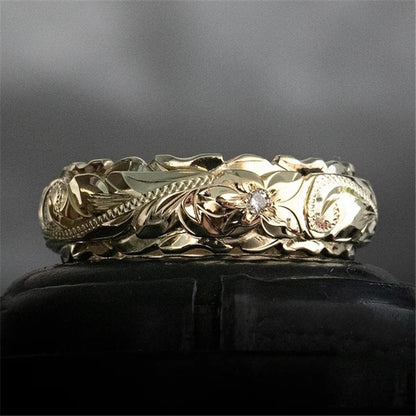 Rose flower carved gold ring band displayed on a stand, styled product shot