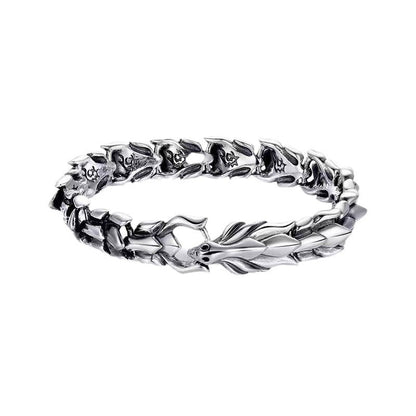 Silver-tone dragon chain bracelet flat lay on white background