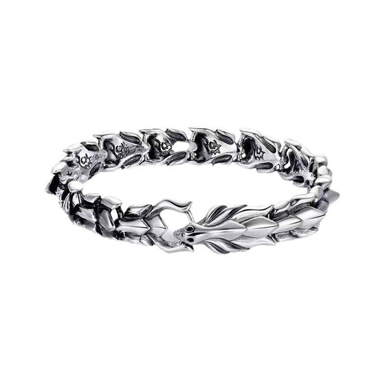 Silver-tone dragon chain bracelet flat lay on white background