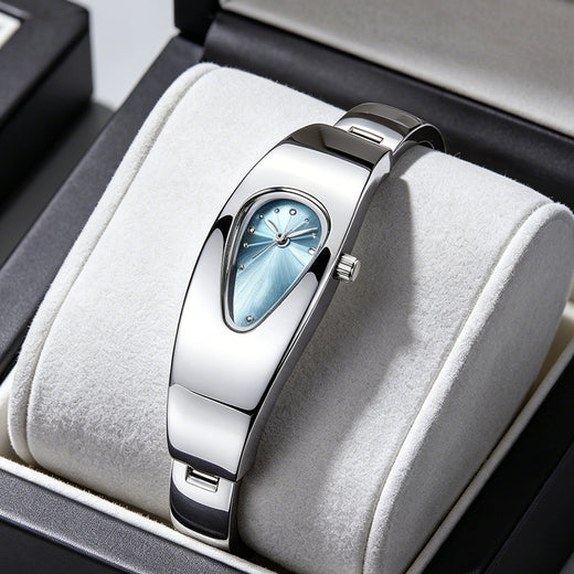 Silver stainless steel water drop watch with blue teardrop dial, front view on jewelry cushion