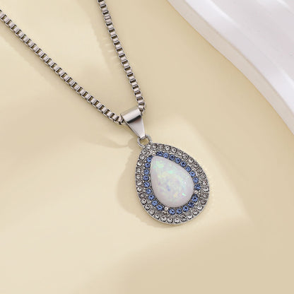 Silver box chain necklace with teardrop opal pendant, flat lay view