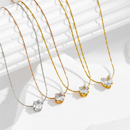 Gold-tone, rose gold-tone, and silver-tone six claw pendant necklaces with clear stone pendant, arranged side by side