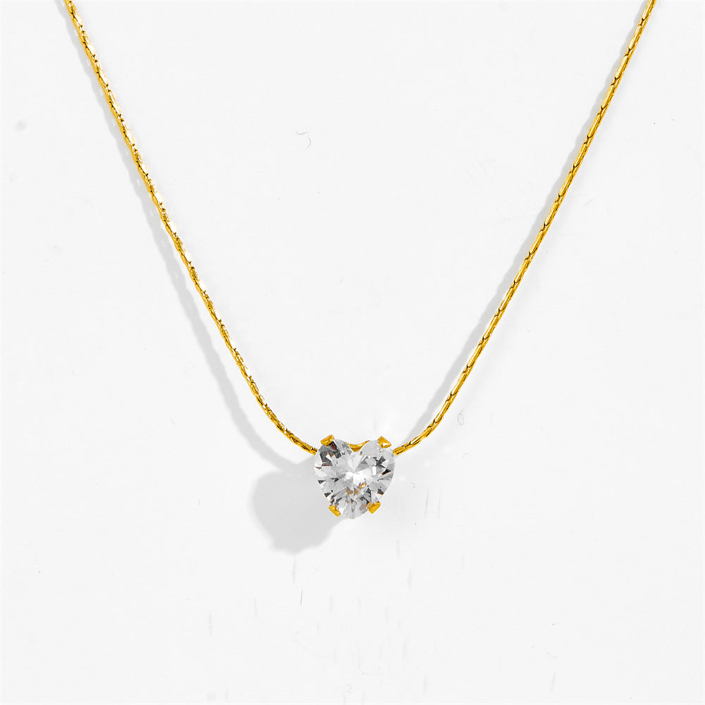 Close-up of gold-tone six claw pendant necklace with clear stone pendant