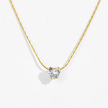 Close-up of gold-tone six claw pendant necklace with clear stone pendant